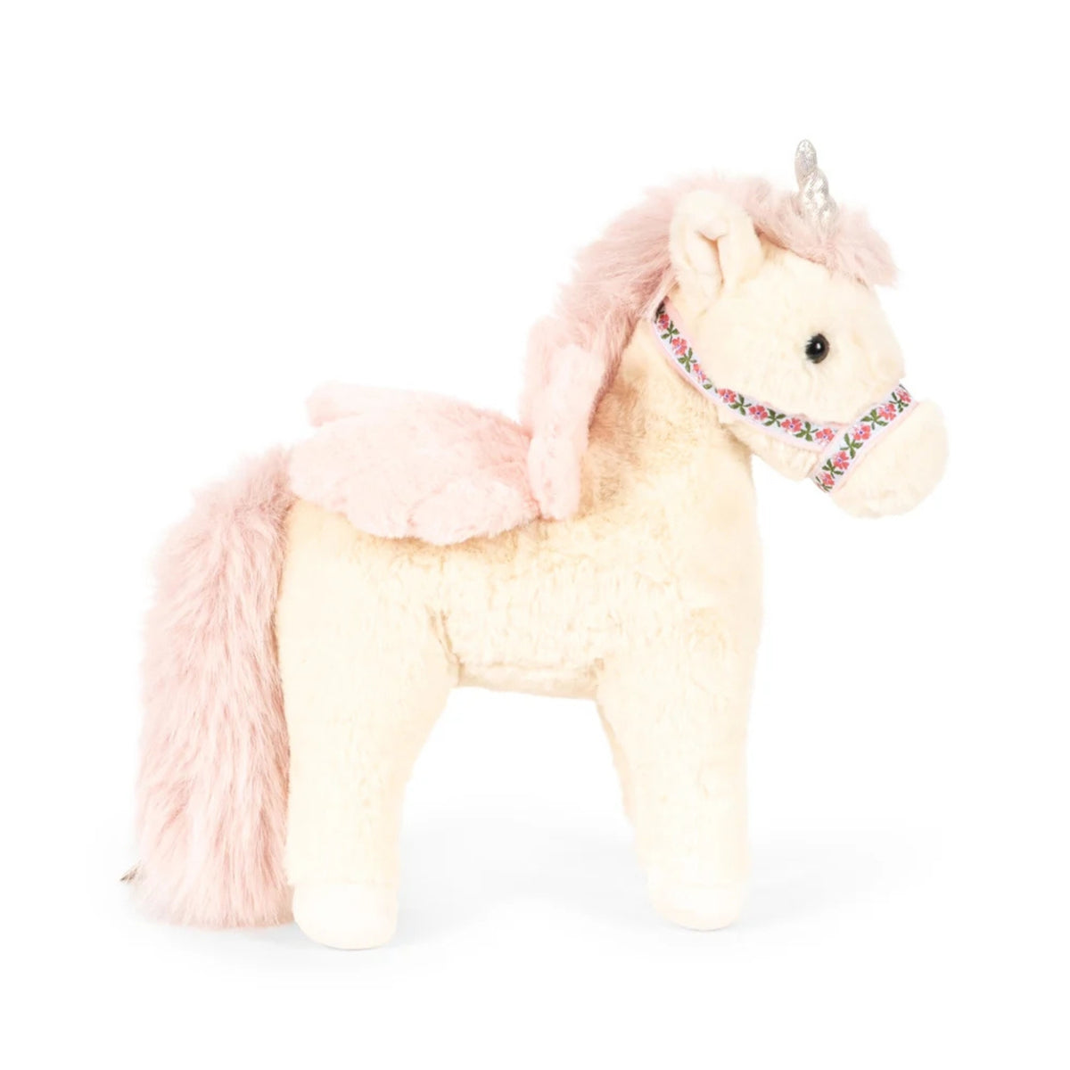 A plush unicorn toy with cream-colored body, light pink mane and tail, small wings, and a decorative floral halter, shown on a plain white background.