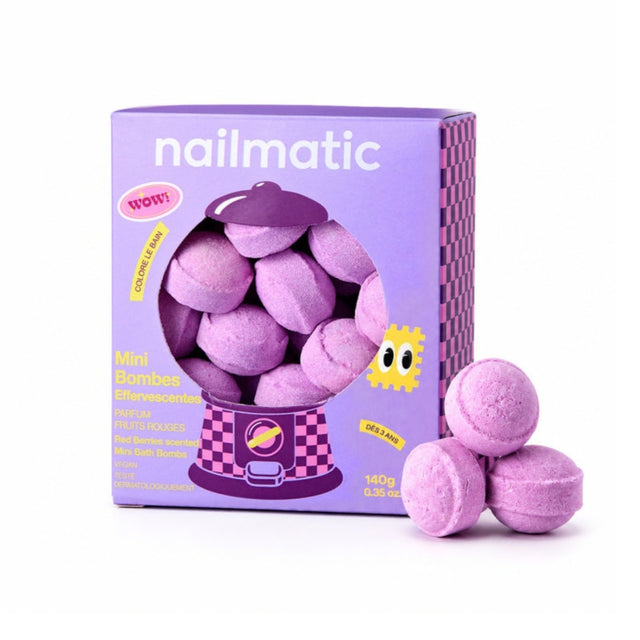 A purple box of nailmatic mini bath bombs with three loose bath bombs placed in front on a clean white background.