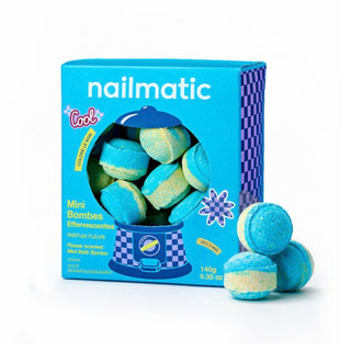 A blue box of Nailmatic Mini Bath Bombs - Flower Power, with several blue and pale yellow round bombs displayed in front on a white background.