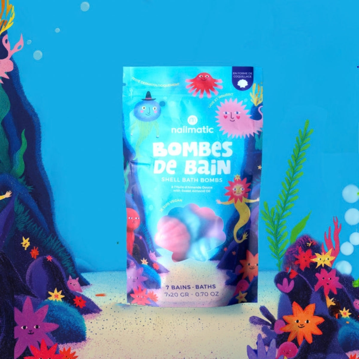 Nailmatic shell bath bomb packaging with an underwater theme on a blue underwater background