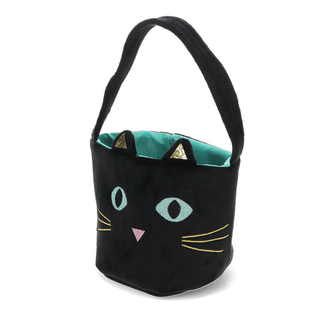 A black plush bucket bag designed to look like a cat's face, featuring embroidered light blue eyes, a pink nose, yellow whiskers, and a teal interior lining with gold triangular ear accents, set against a plain white background.