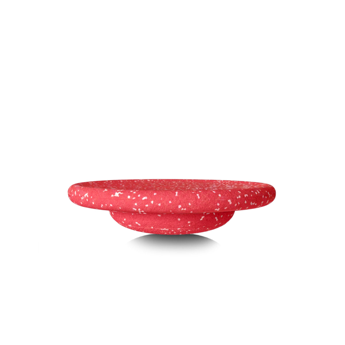 A red speckled round balancing board shown from a side profile view on a white background.