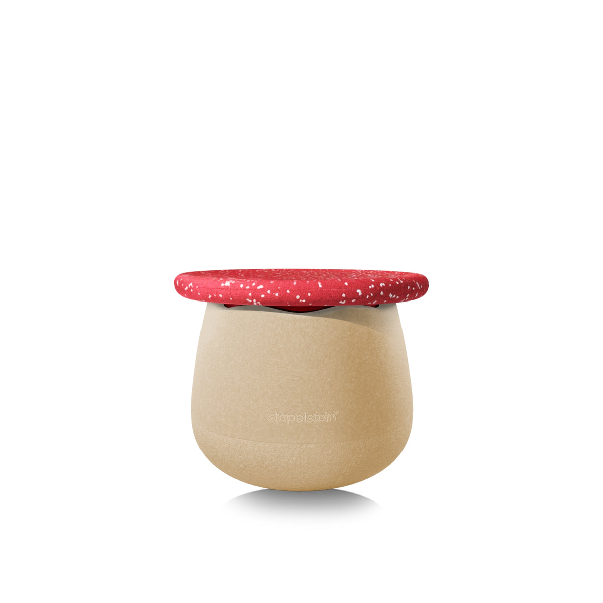 A modern, rounded stool with a textured beige body and a contrasting vivid red speckled with small white dots, shown on a clean white background. Stool resembles a toadstool.