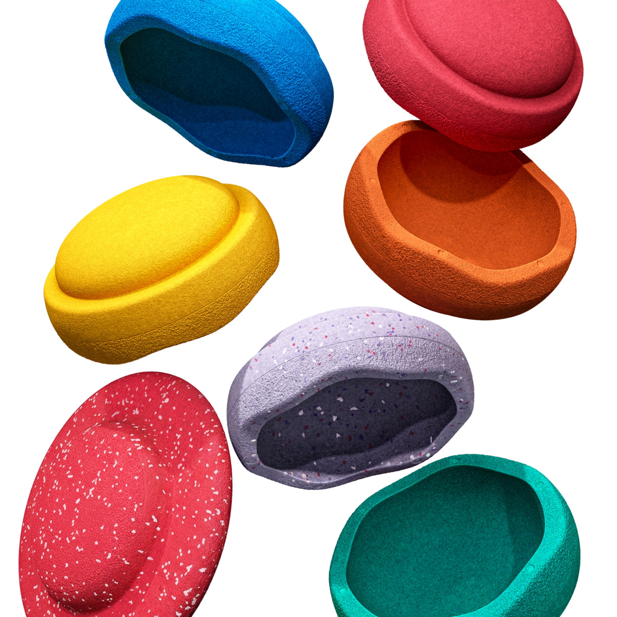 Six Original Stapelstein pieces in bright rainbow colours, with one red speckled board, all falling in mid-air against a white background.