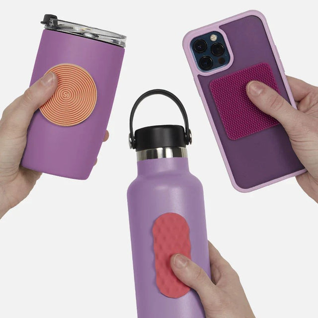 Purple phone case and water bottle with textured grip on a white background